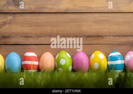 Happy Easter! Background with colorful eggs on the grass. Stock Photo