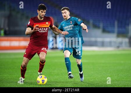 Federico Fazio of Roma (L) vies for the ball with Alexis Saelemaekers of Milan (R) during the Italian championship Serie A football match between AS Roma and AC Milan on February 28, 2021 at Stadio Olimpico in Rome, Italy - Photo Federico Proietti / DPPI / LiveMedia Stock Photo