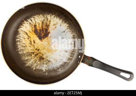 old stained aluminium pan with burnt fat and peeled off TFE - tetrafluoroethylene, non-stick coating and burnt fat in flat lay perspective isolated on Stock Photo