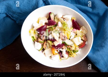 tasty walnut and beet salad with goat cheese crumbled on top Stock Photo