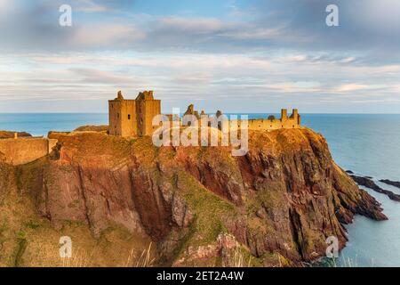 Dunnottar Castle near Stonehaven on the east coast of Scotland bathed in the evening light Stock Photo