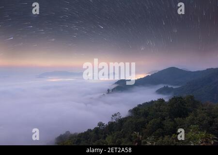 Aerial view of cloud carpet under the milky way at night, Thailand Stock Photo