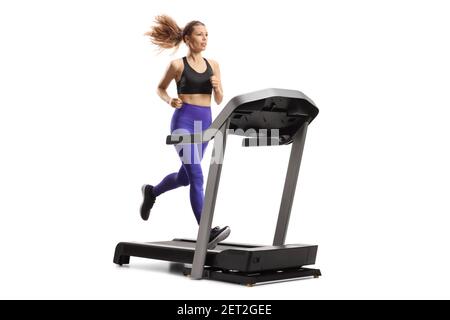 Young woman running on a treadmill machine isolated on white background Stock Photo