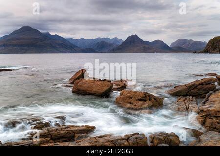 Looking out over the mountains from the rocky beach at Elgol on the Isle of Skye in Scotland Stock Photo