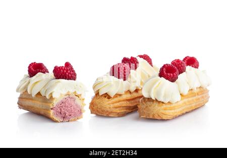 Raspberry eclairs isolated on white background. Tasty french snack. Stock Photo