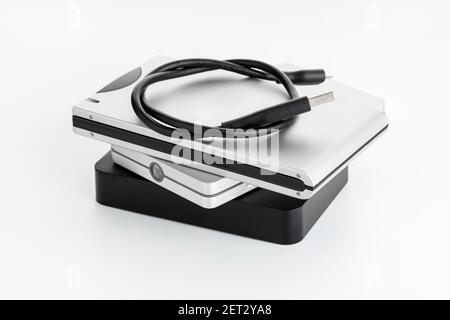 Pile of a group of external Hard disk drive on white table. HDD Data storage concept Stock Photo