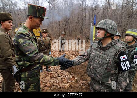 22 November 2018 - DMZ, South Korea : (In this handout photo provided by South Korean Defense Ministry), South Korean soldier (R), shakes hands with a North Korean soldier (L), during a operation to construct a tactical road to support a joint war remains recovery project at the Demilitarized Zone (DMZ) in DMZ, South Korea on November 22, 2018. The two Koreas connected the 3 km-long road at Arrowhead Ridge, a site of fierce battles in the 1950-53 Korean War. (Photo by South Korean Defense Ministry/Sipa USA)