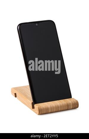 Smartphone stands on wooden stand isolated on white background Stock Photo
