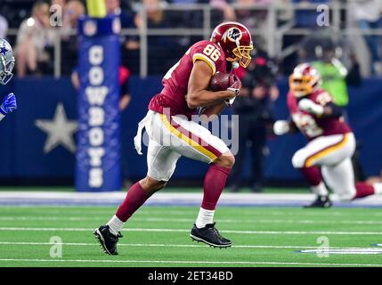 November 22, 2018:.Washington Redskins quarterback Colt McCoy (12) tries to  elude Dallas Cowboys defensive tackle Daniel Ross (93) as he accidentally  pulls on the face mask during an NFL football game between