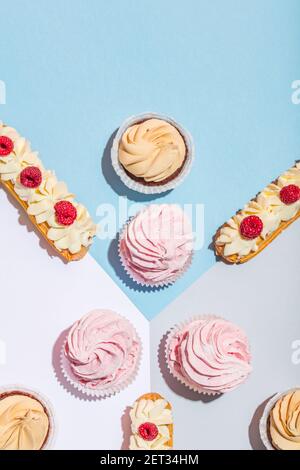 Sweet cakes on pastel background in a composition. Delicious treat. Flat lay. Stock Photo