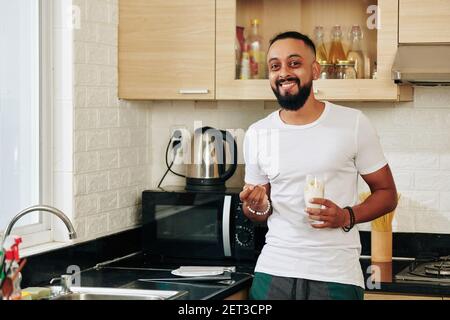 Man eating non-dairy yogurt Stock Photo