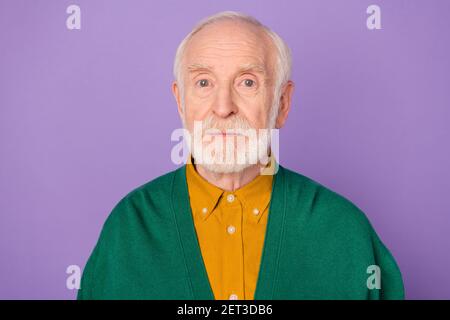 Photo of aged person no emotions face look camera wear orange shirt isolated on pastel violet color background Stock Photo