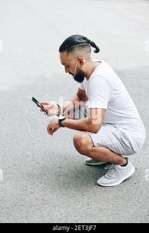 Man watching video on phone Stock Photo