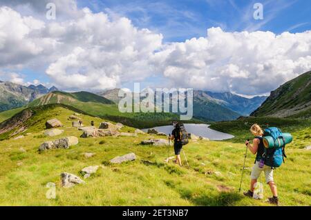 Hikers with big backpacks on multi-day tour in Lagorai mountains Stock Photo