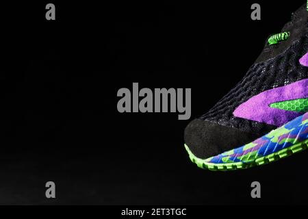 Multi-colored sports sneakers on a black background. Bright colors modern colors. Sporty style, close-up Stock Photo