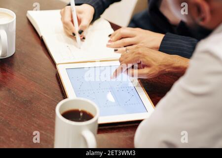 Business people pointing at line chart Stock Photo