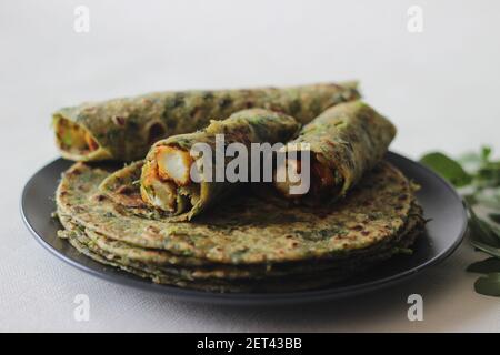 Whole wheat methi thepla rolls with paneer capsicum filling and a bowl of masala curd. A healthy, flavourful , tasty flat bread made of whole wheat, s Stock Photo