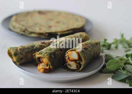 Whole wheat methi thepla rolls with paneer capsicum filling and a bowl of masala curd. A healthy, flavourful , tasty flat bread made of whole wheat, s Stock Photo