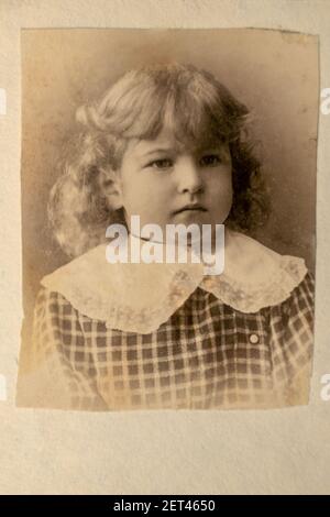 Russia - CIRCA 1890s: Portrait of little girl in studio. Vintage archive Edwardian era photography. Close up face. Carte de Viste cabinet card Stock Photo