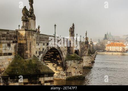 Postcard view of Charles Bridge and Lesser Town in mist,Czech republic.Famous tourist destination.Prague panorama.Foggy morning in city.Amazing Europe