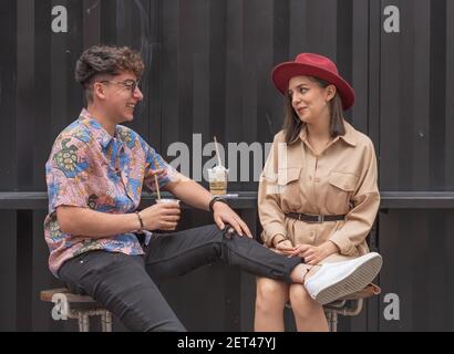 Young couple enjoying a nice afternoon together. Sharing good times enjoying a drink. Stock Photo