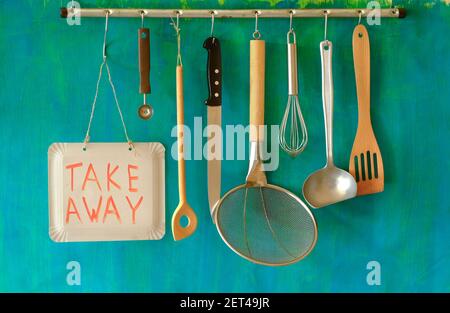 Restaurant announcing food delivery during corona virus lockdown, kitchen utensils and take awy sign,food delivery concept Stock Photo