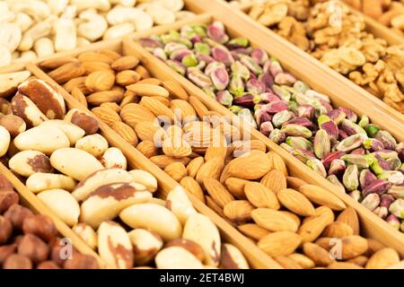 The heap of various nuts in the wooden box. Stock Photo