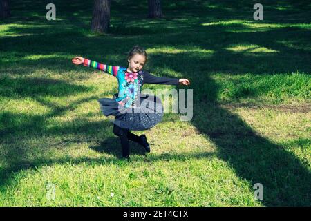 Girl dancing in a park, Italy
