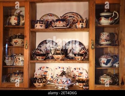 China. Dresser of antique, vintage china. Colourful eclectic collection of traditional Staffordshire china. Plates , teapots etc.Still life.Full frame. Stock Photo