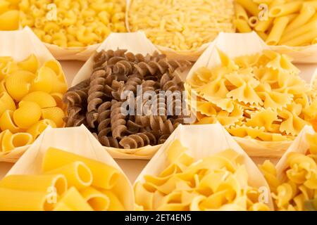 Various kind of Italian pasta in the bamboo bowls. Stock Photo