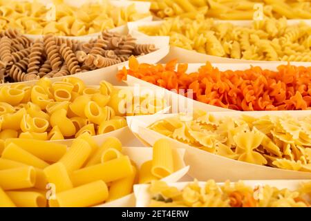 Various kind of Italian pasta in the bamboo bowls. Stock Photo