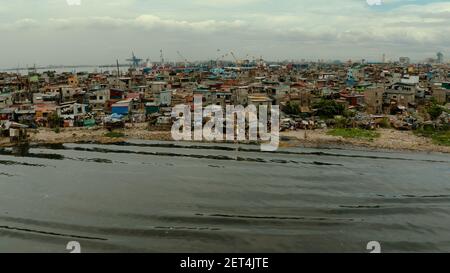 Slum area near the port in Manila, Phillippines, top view. lot of garbage in the water. Stock Photo