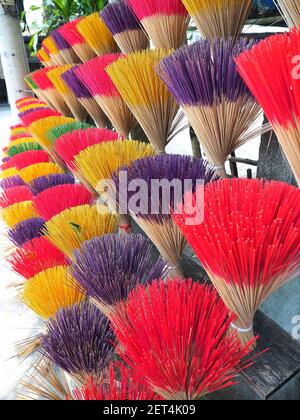 Arranged handmade colorful incense sticks made in Thuy Xuan village near Hue, Vietnam. Vertical shot. Stock Photo