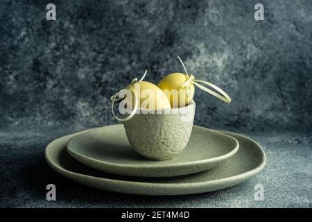 Two Easter eggs in a ceramic bowl arrangement Stock Photo