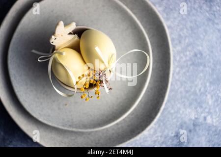 Two Easter eggs in a ceramic bowl arrangement Stock Photo