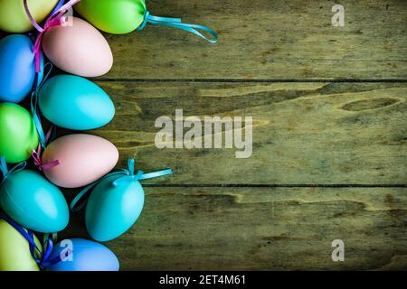 Overhead view of multi coloured Easter Eggs lying on a wooden table Stock Photo