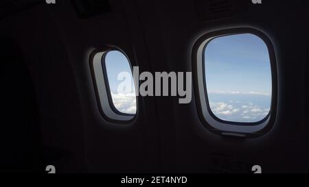 Looking through the Airplane Window .Clouds in the aircraft's porthole. Stock Photo