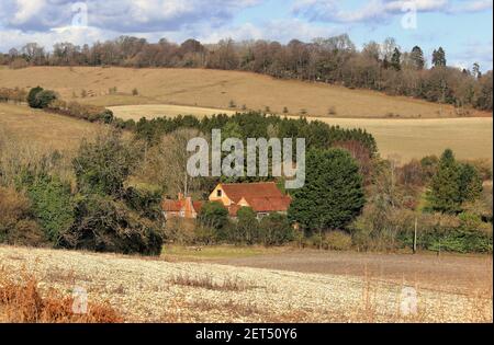 An English Rural Landscape in th Chiltern Hills in Winter sunshine with houses in the valley Stock Photo