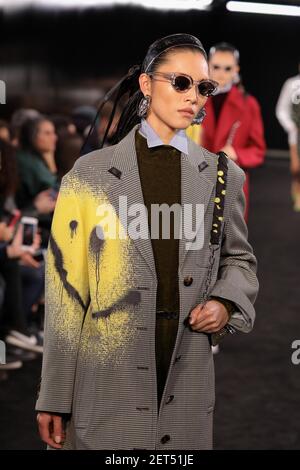 A model, sunglasses detail, walks the runway at the Fendi show