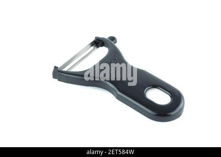 Vegetable peeler with black plastic holder isolated on white background. Stock Photo