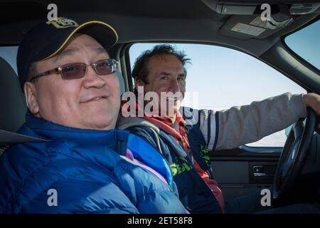 E. Gruben's Transport President Merven Gruben and Chief Executive Officer Russell Newmark in truck on Inuvik-Tuktoyaktuk Highway, winter construction. Stock Photo