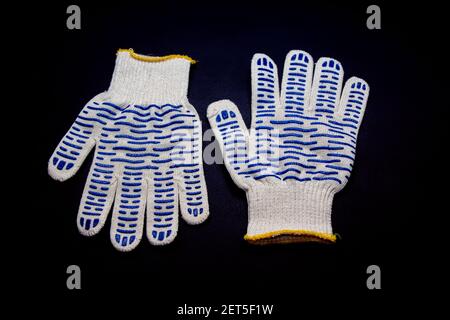 New working gloves with rubber protective layer for construction and repair on black background Stock Photo
