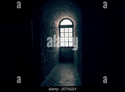 Sunlight shines through a window in an old castle and is reflected in the floor. Stock Photo