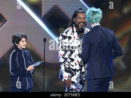 LOS ANGELES - DECEMBER 6: Presenters Sunny Sulijic and Christopher Judge  appear onstage at the 2018 Game Awards at the Microsoft Theater on December  6, 2018 in Los Angeles, California. (Photo by