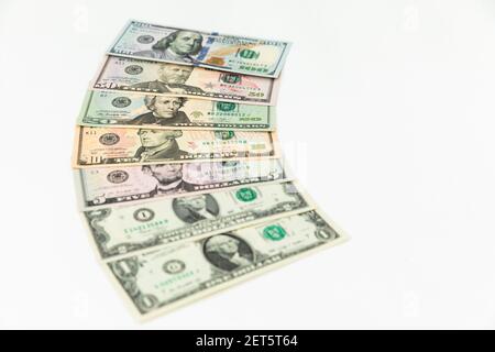 US dollars. Finance background of 5, 10, 20, 50 and 100 dollar bills on white Stock Photo