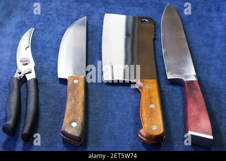 The kitchen knife collections on the blue background, tools, and instruments for cooking. Stock Photo