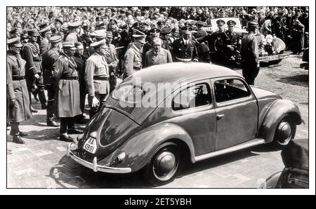 1930's ADOLF HITLER with DR. PORSCHE at the launch event of 'the people's car' KDF VW Volkswagen Beetle prototype a groundbreaking air-cooled motorcar at Fallersleben Wolfsburg Germany May 1938 Adolf Hitler’s Open Top Mercedes Motorcar in background The Mercedes-Benz 770 Grosser Offener Tourenwagen Stock Photo