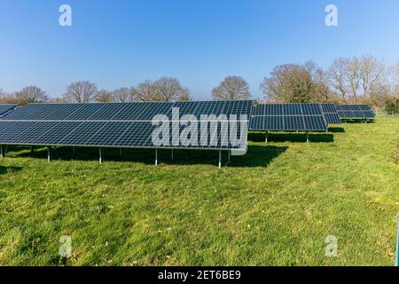 Solar farm with large solar panels in an array, West Sussex, England Stock Photo