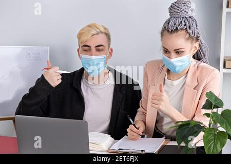 Corporate business, online conference. Young modern people communicate using laptop explaining business development strategy. Successful professional Stock Photo