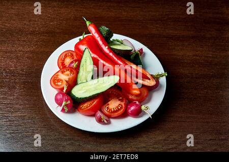 slicing fresh vegetables on a plate Stock Photo